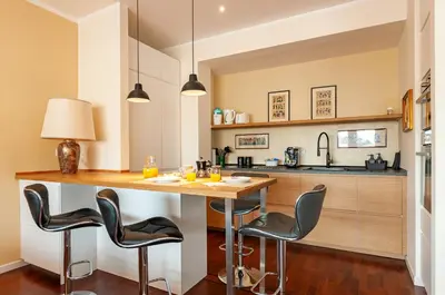 a kitchen with a large wooden table and chairs at L'Attico di Katia in Rome