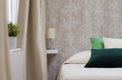 a bedroom with a bed with green and white pillows at St Peter Vatican Lovely Apartment & Patio, Rome in Rome