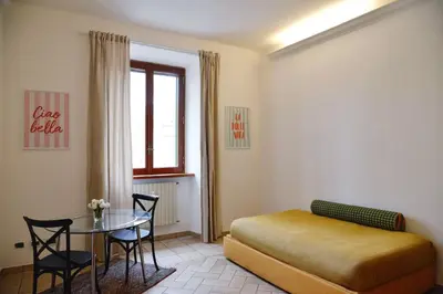 a bedroom with a bed and a table with chairs at Casa Iulia - Raffinata dimora nel cuore di Roma in Rome