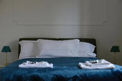 two towels on a bed with two cats in them at Casa Iulia - Raffinata dimora nel cuore di Roma in Rome