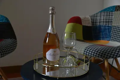 a bottle of wine and a glass on a table at Casa Iulia - Raffinata dimora nel cuore di Roma in Rome