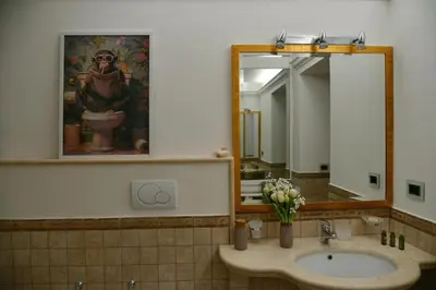 a bathroom with a sink and a large mirror at Casa Iulia - Raffinata dimora nel cuore di Roma in Rome