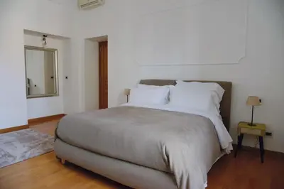 a bedroom with a large bed with white pillows at Casa Iulia - Raffinata dimora nel cuore di Roma in Rome