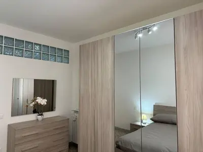 a bedroom with a bed and a mirror at Bonelli 22 Apartment in Rome