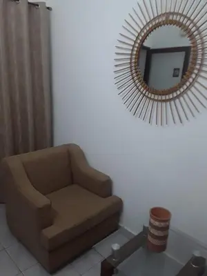 a living room with a chair and a mirror at Emmanuella Casa in Rome