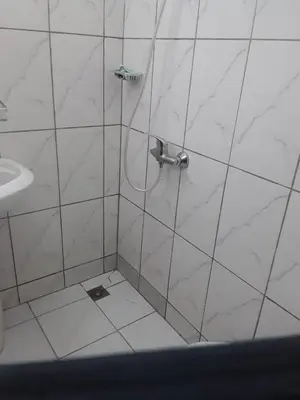a shower in a white tiled bathroom with a sink at Emmanuella Casa in Rome