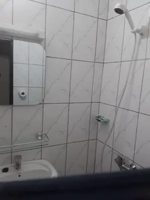 a white tiled bathroom with a sink and a shower at Emmanuella Casa in Rome