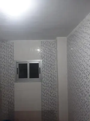 a bathroom with a window and a tile wall at Emmanuella Casa in Rome