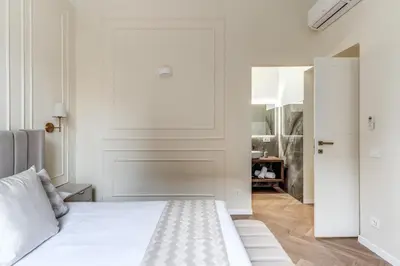 a white bedroom with a bed and a closet at 3 minutes walk from Termini Station With Temple View in Rome