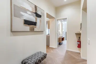 a living room with a couch and a painting on the wall at 3 minutes walk from Termini Station With Temple View in Rome