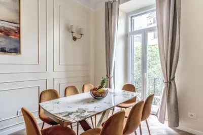 a dining room with a table and chairs at 3 minutes walk from Termini Station With Temple View in Rome