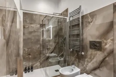 a bathroom with a shower and a toilet and a sink at 3 minutes walk from Termini Station With Temple View in Rome