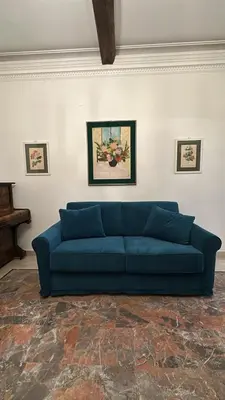 a blue couch sitting in a living room at Borgo Pio Vatican in Rome