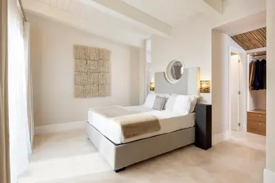 a bedroom with a bed and a painting on the wall at Exclusive Home with pool and iconic View on Saint Peter in Rome
