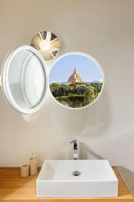 a bathroom with a mirror and a white sink at Exclusive Home with pool and iconic View on Saint Peter in Rome