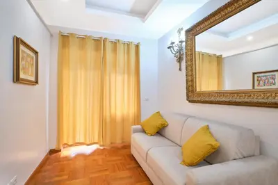 a living room with a couch and a mirror at 2ND Level in Rome