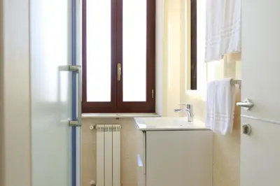 a bathroom with a sink and a window at Villa Aurora Rooms in Rome