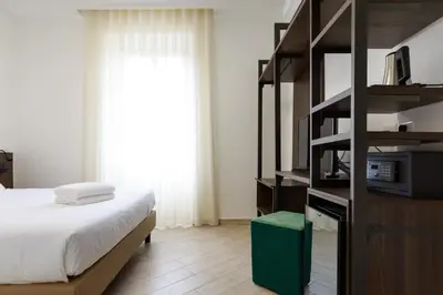 a bedroom with a bed and a book shelf at Villa Aurora Rooms in Rome