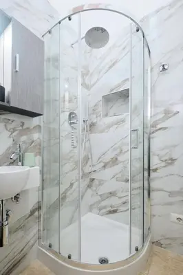a glass shower in a bathroom with a sink at 5 Cozy Pigneto Apt, Wifi & AC in Rome