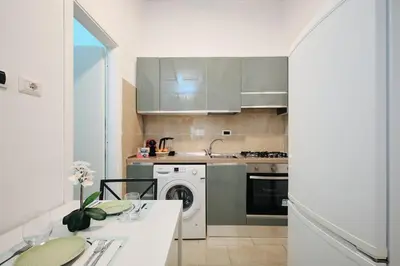 a kitchen with a washing machine and a sink at 5 Cozy Pigneto Apt, Wifi & AC in Rome