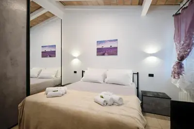 two beds in a room with towels on them at 5 Cozy Pigneto Apt, Wifi & AC in Rome