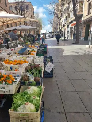 a market with fruits and vegetables in baskets on a street at A Casa di Mario al Pigneto in Rome