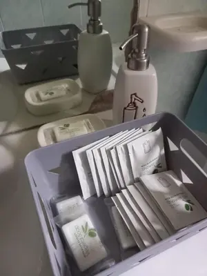 a sink with a container of soap and toothbrushes at A Casa di Mario al Pigneto in Rome