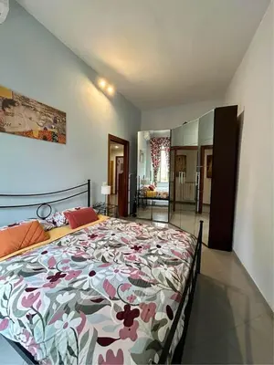 a bedroom with a large bed with a floral bedspread at A Casa di Mario al Pigneto in Rome