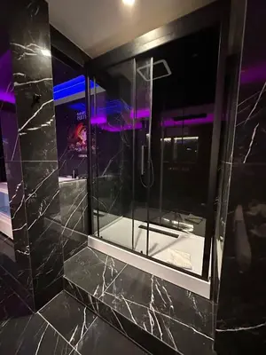 a bathroom with a shower with a glass window at Gladiatrice Suite in Rome