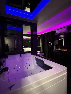 a white tub in a room with purple lights at Gladiatrice Suite in Rome