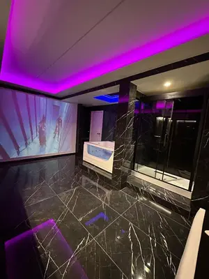 a bathroom with a tub and purple lighting at Gladiatrice Suite in Rome