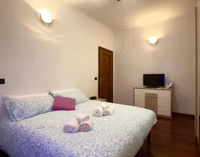 a bedroom with a bed with towels on it at Mancinelli Rome Apartment in Rome
