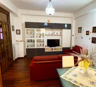 a living room with a red couch and a television at Mancinelli Rome Apartment in Rome