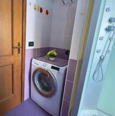 a laundry room with a washing machine in a bathroom at Mancinelli Rome Apartment in Rome