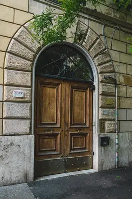 a large wooden door in a brick building at Habitat 42 Roman Stay in Rome