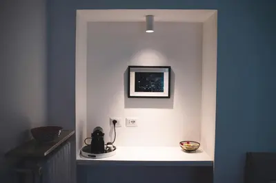 a room with a white wall with a picture on it at Habitat 42 Roman Stay in Rome
