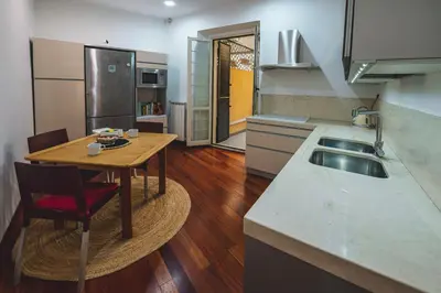 a kitchen with a wooden table and a sink at Habitat 42 Roman Stay in Rome