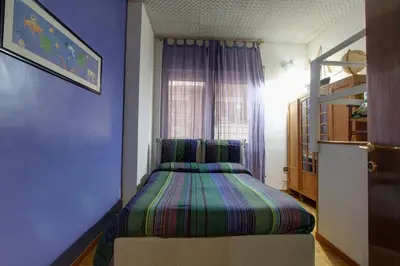 a bedroom with a bed in a blue room at Le Note Di Angela in Rome