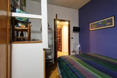 a bedroom with purple walls and a bed and a doorway at Le Note Di Angela in Rome