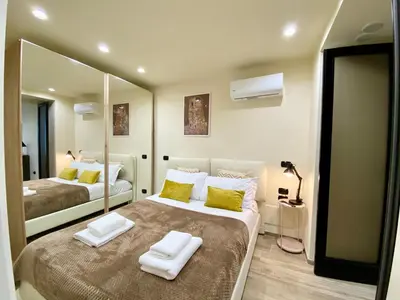 a bedroom with two beds and a large mirror at PIRAMIDE Romantic Home in Rome