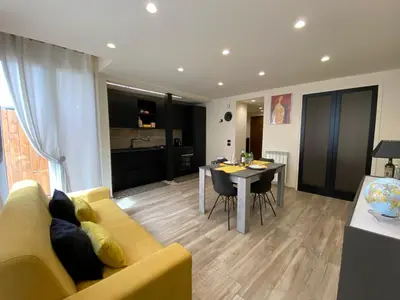 a living room with a yellow couch and a table at PIRAMIDE Romantic Home in Rome