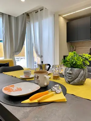 a table with plates and utensils on top of it at PIRAMIDE Romantic Home in Rome