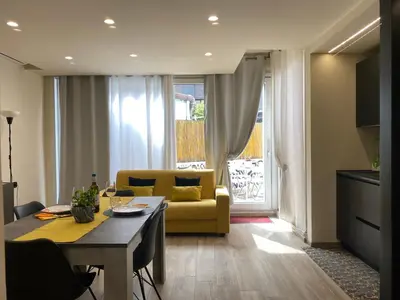 a living room with a yellow couch and a table at PIRAMIDE Romantic Home in Rome
