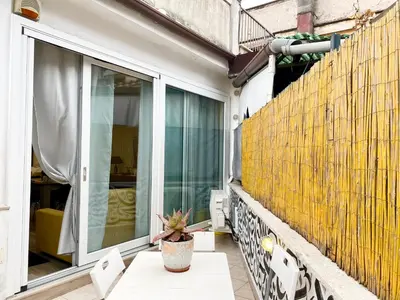 a balcony with a table and a yellow wall at PIRAMIDE Romantic Home in Rome