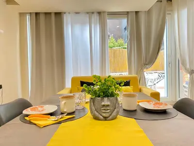 a dining room table with a yellow table cloth at PIRAMIDE Romantic Home in Rome