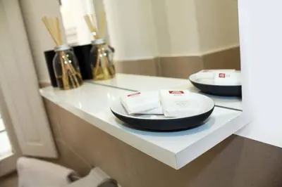 a white counter top with plates on top of it at Roma Resort Colosseum in Rome