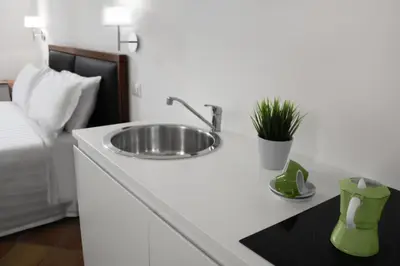 a bathroom with a sink on a counter next to a bed at Roma Resort Colosseum in Rome