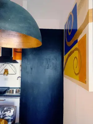a kitchen with a counter with a surfboard on the wall at St Peter Vatican- Stylish Apt, Roma in Rome