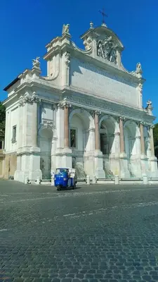 a large building with a blue car in front of it at St Peter Vatican- Stylish Apt, Roma in Rome