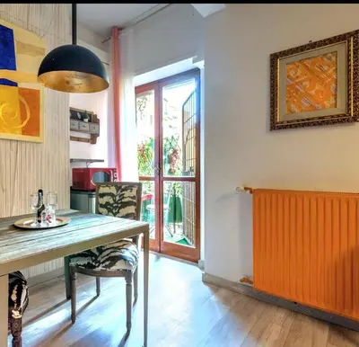 a dining room with a table and a window at St Peter Vatican- Stylish Apt, Roma in Rome